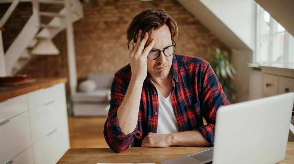 Person reviewing credit card statements and worrying about debt