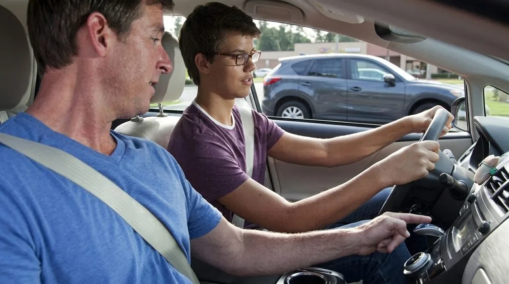 Young driver behind the wheel of a car during a lesson