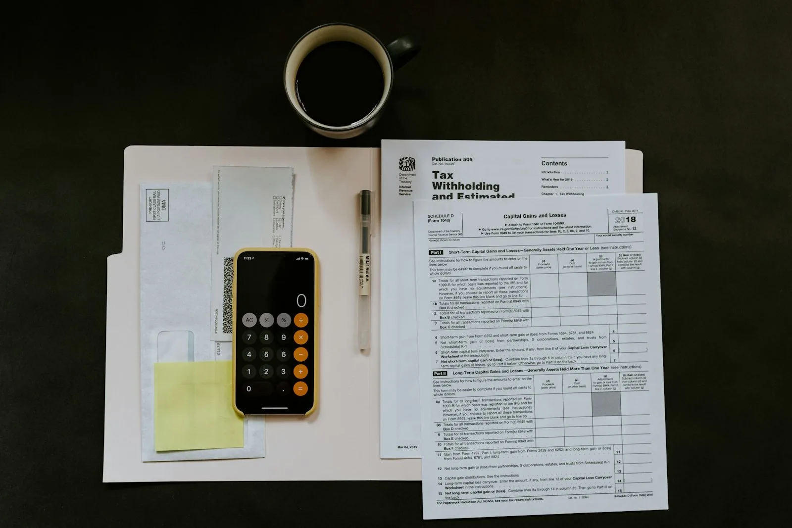 Calculator and paycheck documents for figuring take-home pay