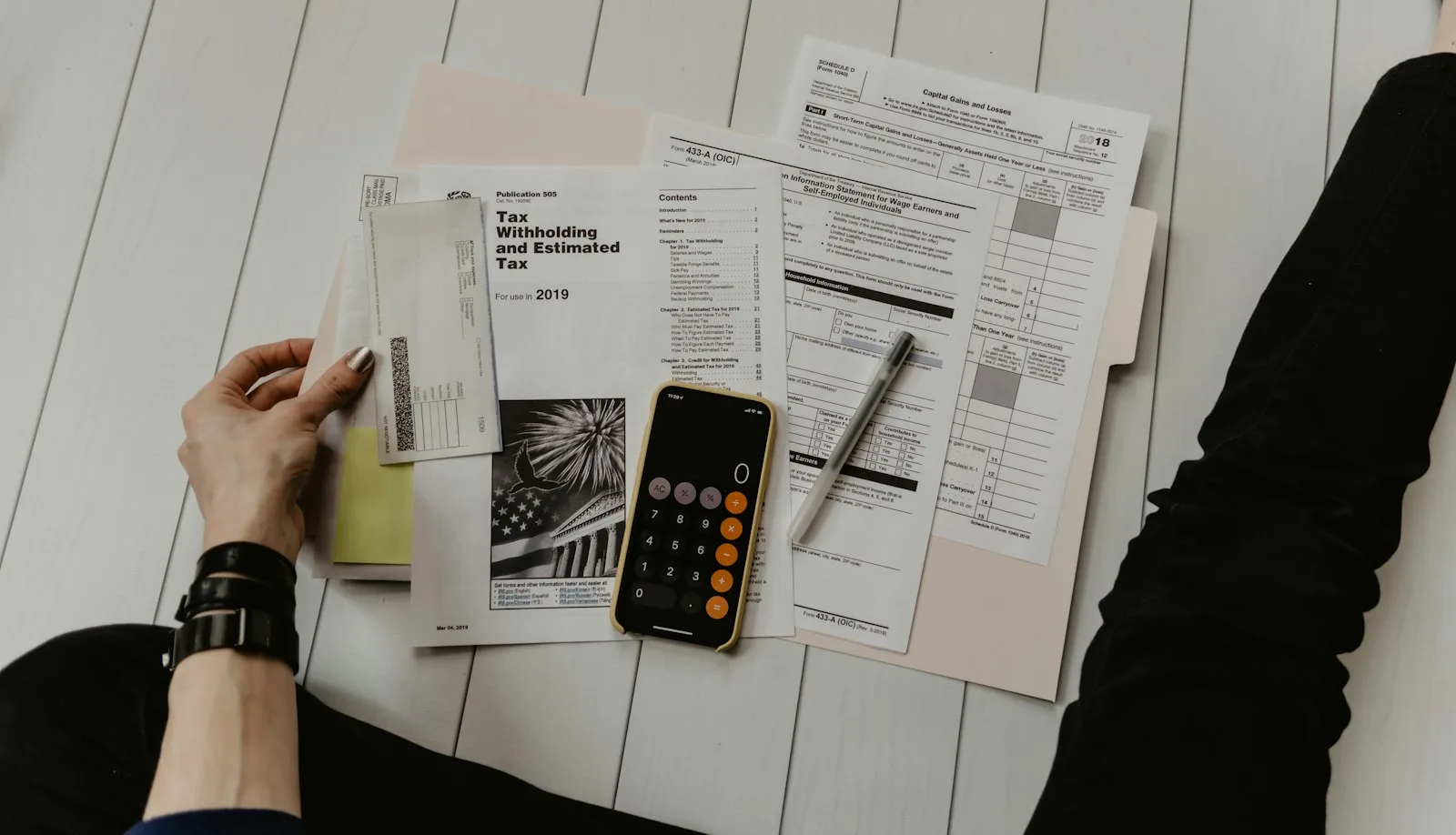Desk with financial documents, calculator, and planning notes for credit factors