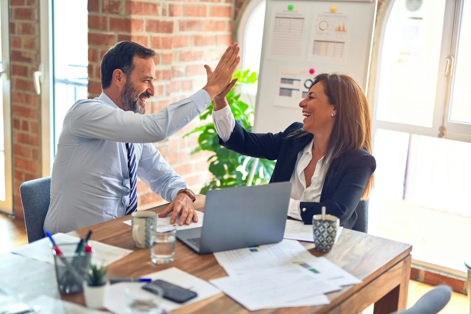 Two colleagues reviewing shared financial plans at a table