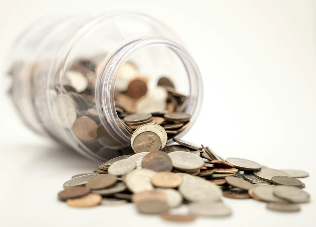 Glass jar of coins symbolizing CD ladder pros and cons