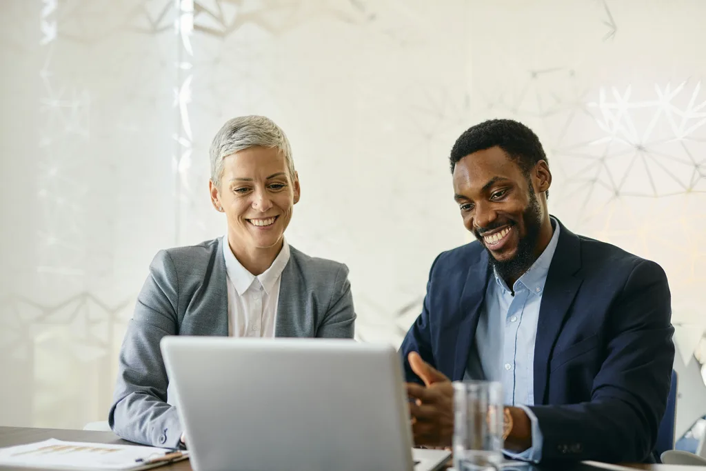 Two professionals collaborating on software project in office
