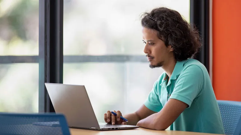 Student applying for financial aid online on laptop
