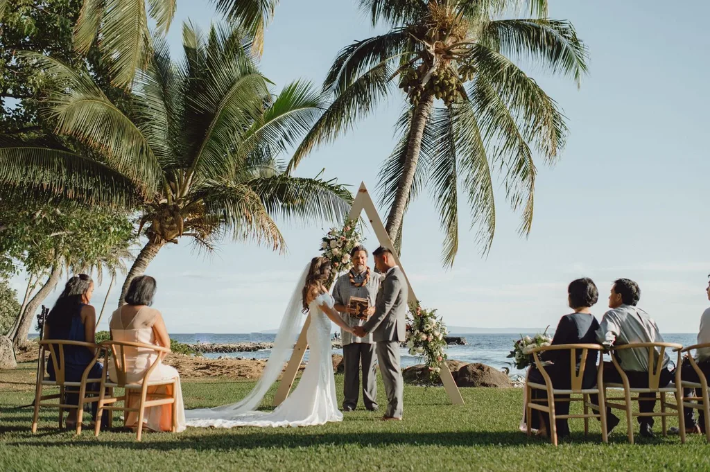Destination wedding couple at outdoor venue with palm trees