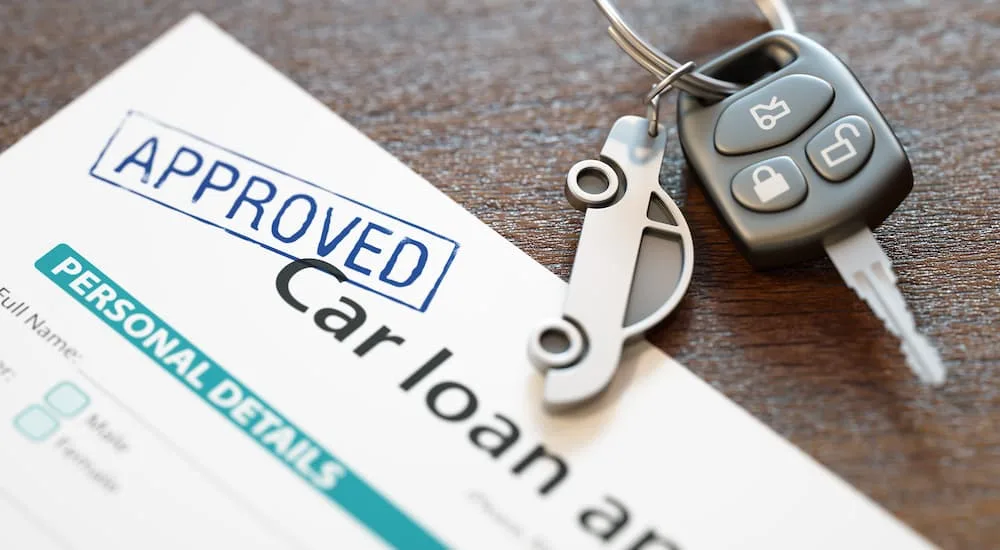 Approved car loan document with car keys