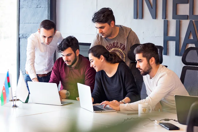 Business team collaborating on SaaS software in office